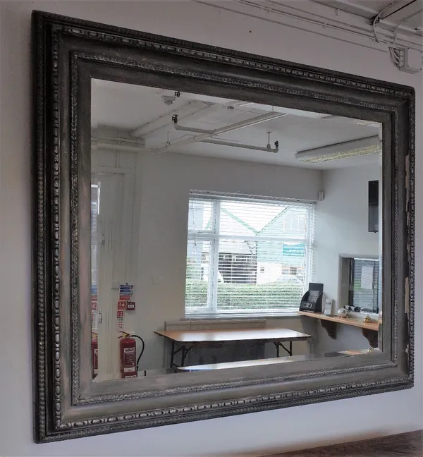 A large silver painted rectangular wall mirror, with egg and dart moulded frame and bevelled plate, 183cm wide x 152cm high.