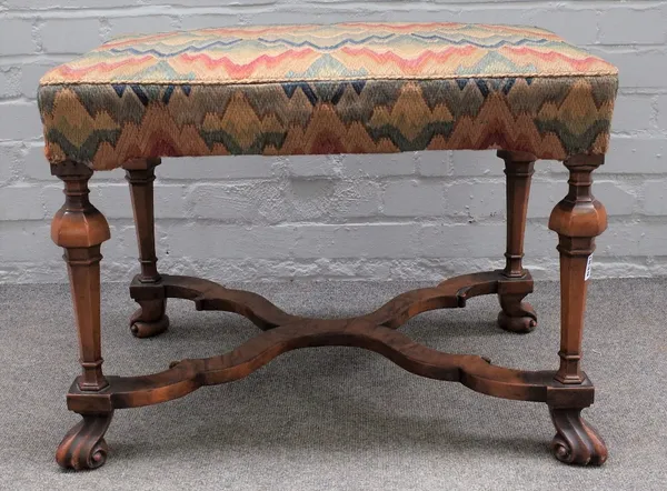 A late 17th century style rectangular walnut footstool, on tapering hexagonal supports and knoll feet, 69cm wide 50cm high.