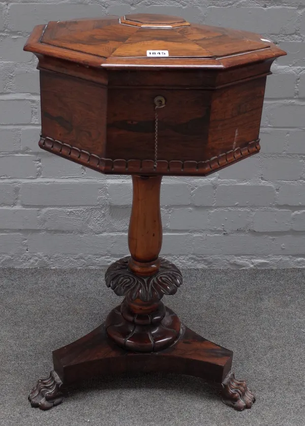 A Regency rosewood octagonal teapoy, with four canister interior on carved column on three paw feet, 44cm wide x 76cm high.