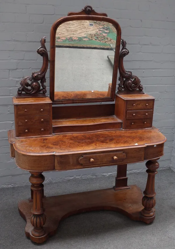 A Victorian figured walnut duchess dressing table, on turned and fluted supports united by platform undertier, 122cm wide x 168cm high.