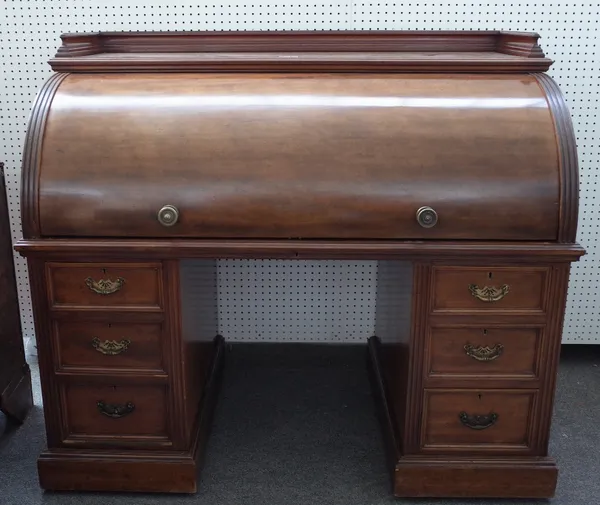 A Victorian mahogany roll top desk, with fitted interior, over six pedestal drawers, 138cm wide x 120cm high.