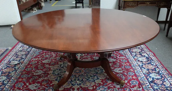 Probably William Tillman or Brights of Nettlebed; a George III style mahogany circular dining table on four turned columns and downswept supports, 169