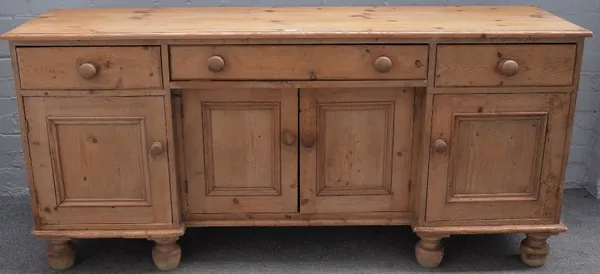 A Victorian pine dresser base with three drawers over four cupboards on turned feet, 172cm wide x 80cm high.