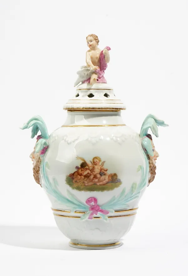 A Berlin porcelain two-handled pot pourri vase and cover, late 19th century, painted with a vignette of three putti, having bearded mask head handles,