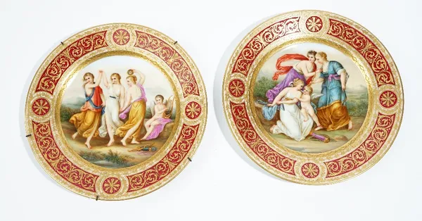 A pair of Vienna style plates, late 19th/early 20th century, painted with titled scenes, Die drei Grazien and  Amor & die Drei Grazien, inside claret