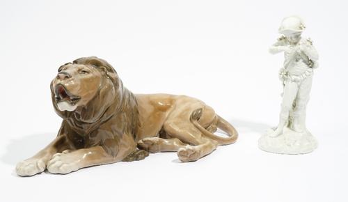 A Royal Copenhagen white glazed porcelain figure representing Autumn,  early 20th century, modelled as a youth holding bunches of grapes, various mark
