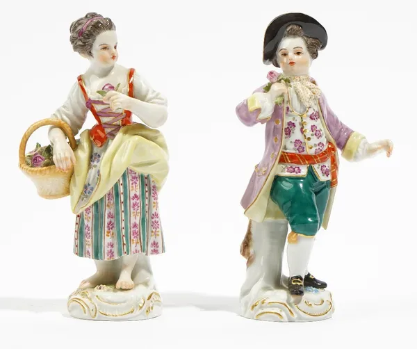 A pair of Meissen figures of gardeners, 20th century, modelled as a youth holding a posy of flowers, his companion with a posy and basket of flowers,