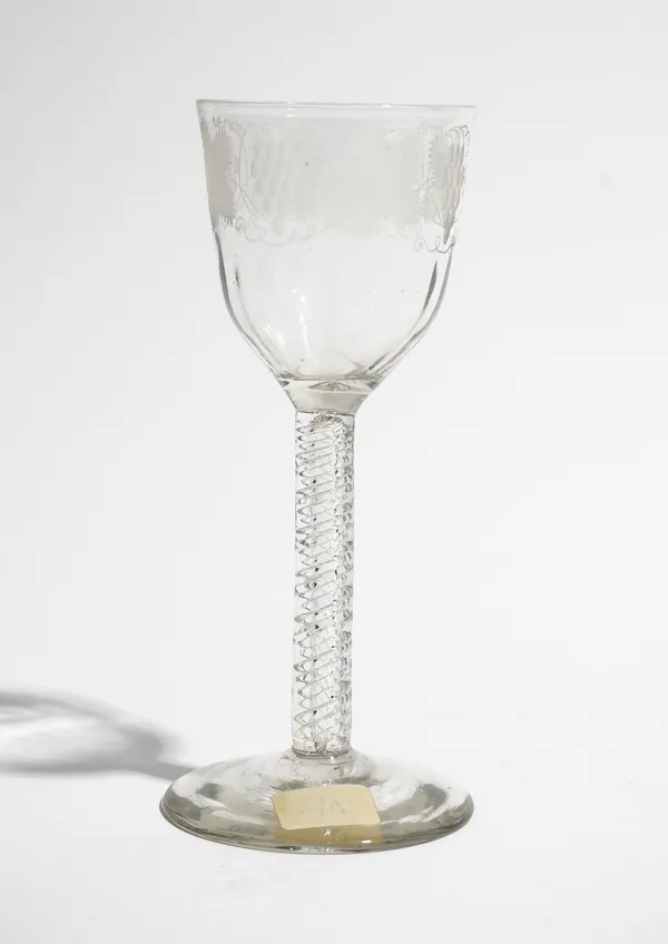 An engraved wine glass, circa 1760, the moulded ogee bowl engraved with fruiting vine, raised on an incised twist stem and plain foot, 16cm. high.