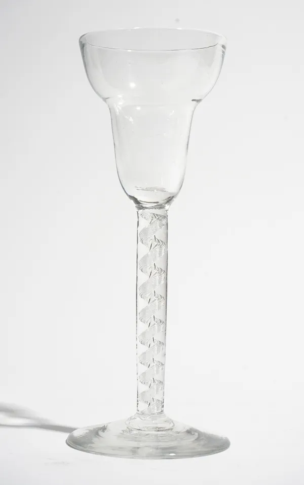 An airtwist wine glass, circa 1750, the pan-topped bowl raised on a single series airtwist stem and plain foot, 15.25cm. high.