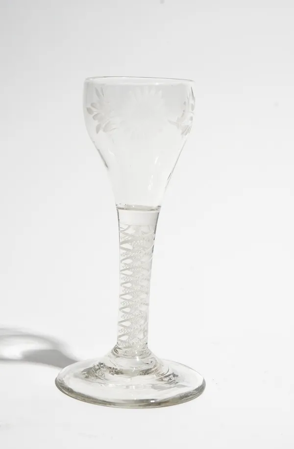 An engraved opaque twist wine glass, circa 1765, the ovoid bowl engraved with a sunflower, raised on a double series opaque twist stem and plain foot,