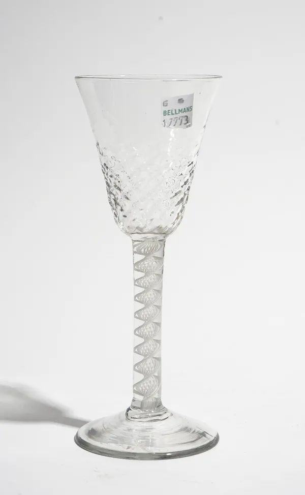 An opaque twist wine glass, circa 1765, the honeycomb moulded rounded funnel bowl raised on a single series opaque twist stem and plain foot, 16.5cm.