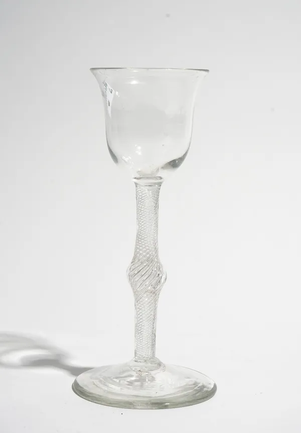 An airtwist wine glass, circa 1750, the tulip bowl raised on a central knopped multi series airtwist stem and plain foot, 15.5cm. high.