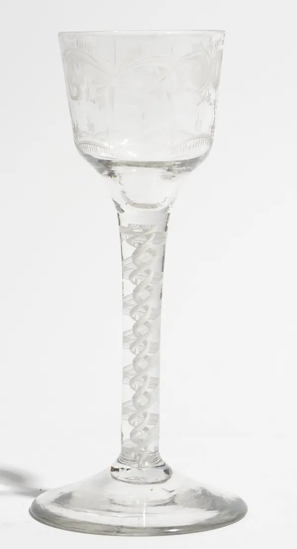 An engraved opaque twist wine glass, circa 1765, the ogee bowl engraved with flowers, raised on a double series opaque twist stem and plain foot, 14.7