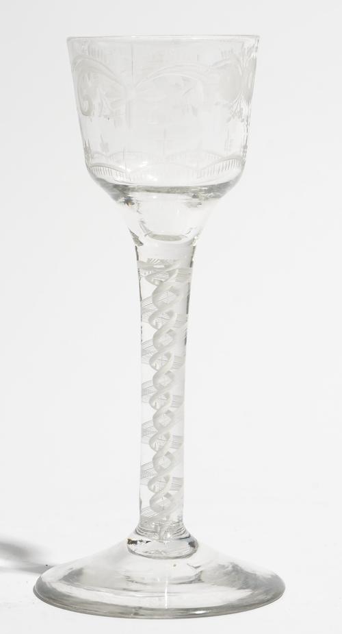 An engraved opaque twist wine glass, circa 1765, the ogee bowl engraved with flowers, raised on a double series opaque twist stem and plain foot, 14.7