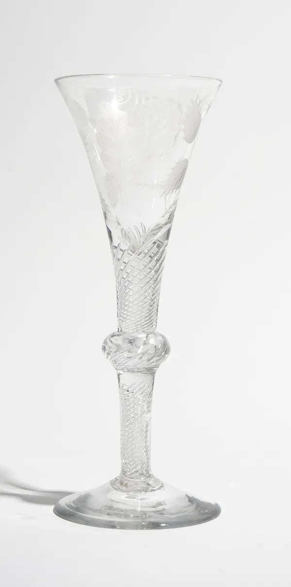 An engraved Jacobite composite stemmed  wine glass, circa 1740, the drawn trumpet bowl engraved with a rose and two buds , the reverse with `Fiat' and