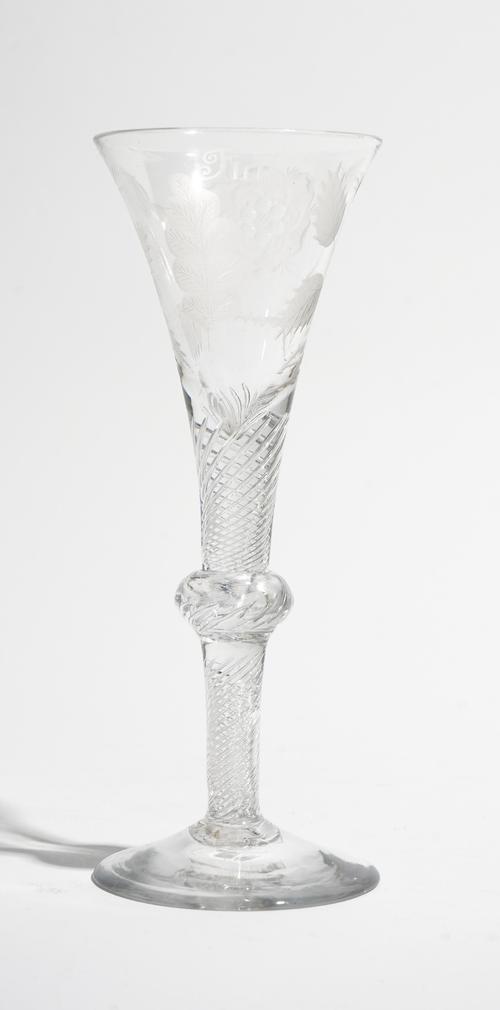 An engraved Jacobite composite stemmed  wine glass, circa 1740, the drawn trumpet bowl engraved with a rose and two buds , the reverse with `Fiat' and