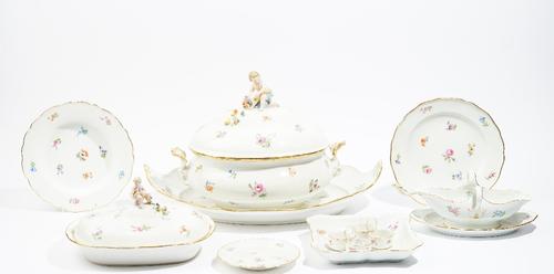 A Meissen porcelain part dinner service, circa 1880, each piece painted with scattered flowers inside a gilt-edged wavy rim, comprising; an oval soup
