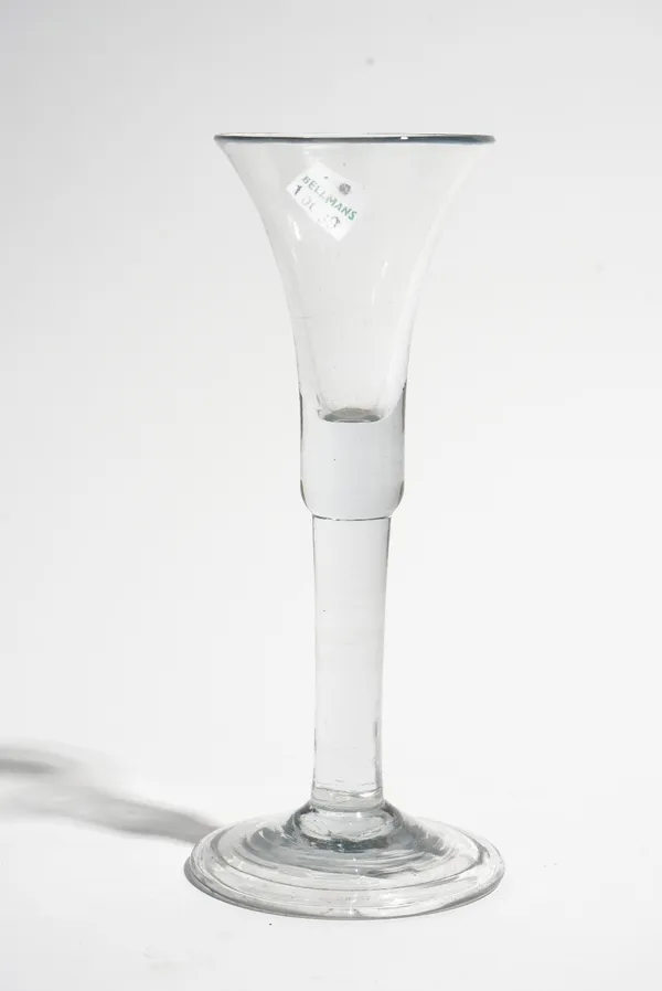 A plain stemmed wine glass, mid 18th century, the waisted bell bowl with solid base, raised on a plain stem and folded foot, 17.25cm. high.