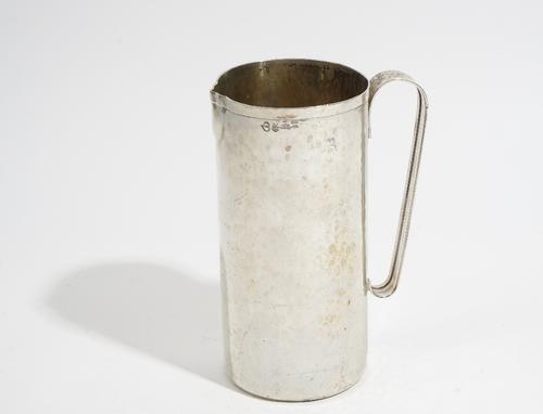 An Italian jug, of cylindrical form with an applied handle, the body with martele decoration, detailed Roma 1977 Giancarlo and marked beneath Lav.a Ma