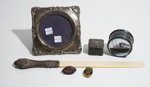 A silver mounted shaped square photograph frame, Birmingham 1914, a silver mounted square stamps box, Birmingham 1904, a silver handled page turner, B