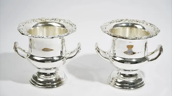 A pair of plated twin handled campana shaped wine coolers, having decorated wide rims.