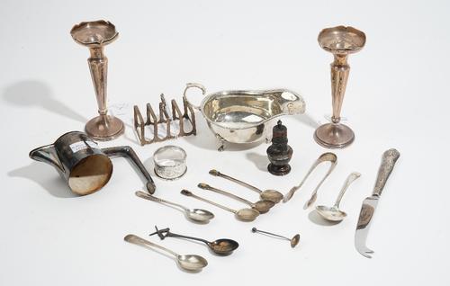 Silver and silver mounted wares, comprising; a sauceboat, a top mount from a claret jug, a toastrack, a pepperette, a napkin ring, a pair of bud vases