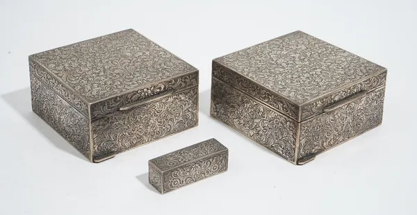 Two European square hinge lidded table cigarette boxes, with floral and scroll engraved decoration, detailed 800, a slide action lipstick, the interio