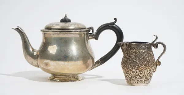 A bachelor's mid 18th century style silver teapot, by Charles Boyton & Sons, London 1918, of baluster form, with blackwood scroll handle and finial to