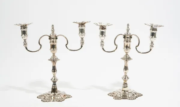 A pair of George II style cast silver twin light table candelabrum, by J B Chatterley & Sons, Birmingham 1965, with baluster form knop stems, shell co