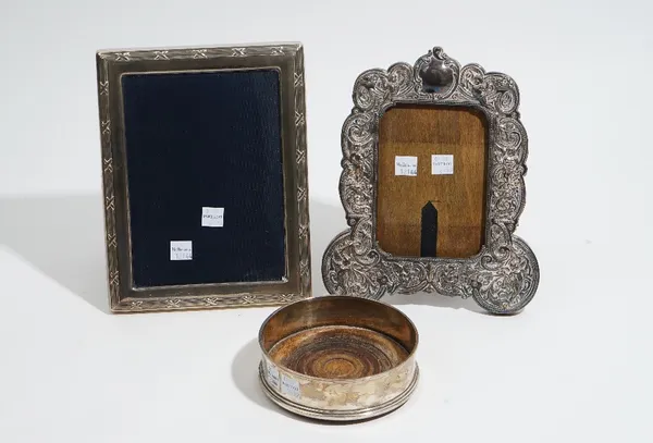 Silver mounted wares, comprising; a rectangular photograph frame, with a decorated border, size of frame 22cm x 17.3cm, a shaped rectangular photograp