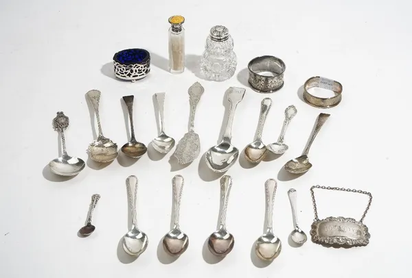 Silver and silver mounted wares, comprising; two napkin rings, an oval salt with a blue glass liner, a salt spoon, a decanter label detailed Brandy, t