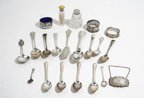 Silver and silver mounted wares, comprising; two napkin rings, an oval salt with a blue glass liner, a salt spoon, a decanter label detailed Brandy, t
