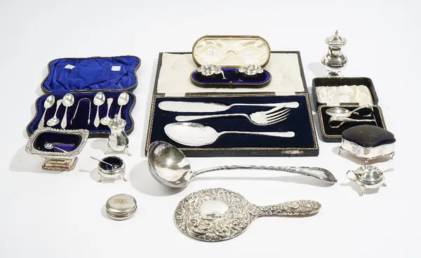 Silver and silver mounted wares, comprising; a hand mirror with embossed decoration, a pin cushion frame box, raised on four feet, a set of six coffee