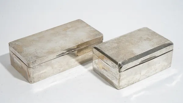 A silver rectangular table cigarette box, the hinged lid engine turned, wooden lined within, length 17.5cm, the hallmark rubbed and a silver smaller r