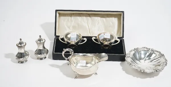 Silver, comprising; a pair of twin handled salts of circular form, Birmingham 1922, cased, a pair of pepperettes, with partly fluted decoration, Chest