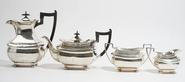 A Regency style four piece silver tea set, comprising; a teapot, a hot water jug, a twin handled sugar bowl and a milk jug, by Walker & Hall, Sheffiel