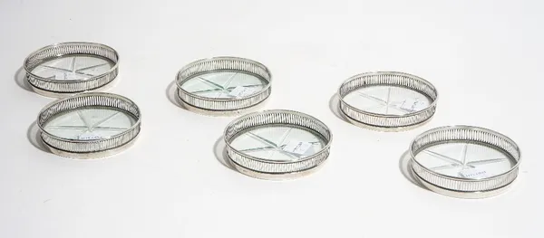 A set of six Sterling silver mounted glass coasters, each cut with a six pointed star to the base and with a pierced gallery surround, detailed Sterli