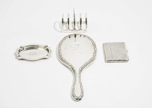 Silver and silver mounted wares, comprising; a five bar toastrack of angular form, London 1933, a hand mirror, London 1921, an oval ashtray, Birmingha