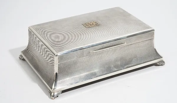 A silver table cigar/cigarette box, of swept rectangular form, wooden lined within with two adjustable divisions, the interior of the lid presentation