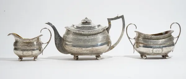 A Scottish silver three piece tea set, comprising; a teapot, Edinburgh 1813, a twin handled sugar bowl, Edinburgh 1813 and a milk jug, Edinburgh 1812,