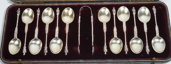 A set of twelve Victorian silver teaspoons, each having cast spiral stems and figure terminals to the handles, in the Dutch taste, with a matching pai