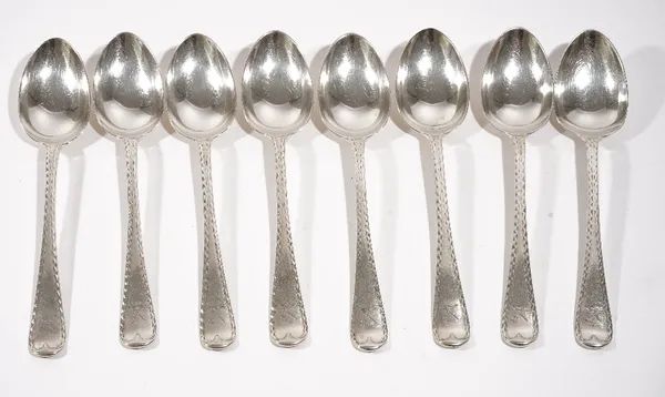 Eight late Victorian Scottish silver single struck feather edged Old English pattern dessert spoons, crest engraved, Edinburgh 1885, combined weight 4