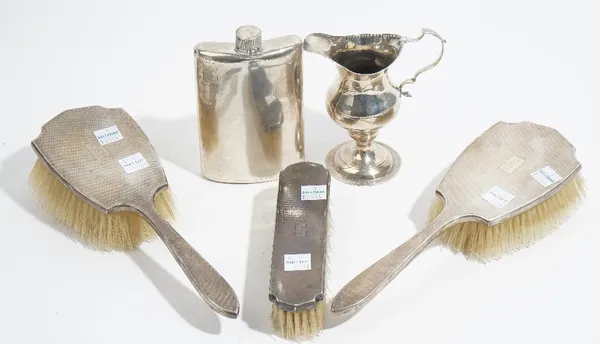 Silver and silver mounted wares, comprising; a George III cream jug, London 1786, (the foot lead loaded), a three piece brush set by Hamilton & Co, wi