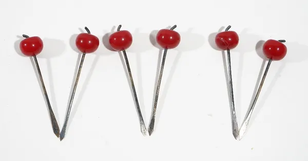 A set of six cocktail sticks, detailed Sterling, having cherry finials, cased.