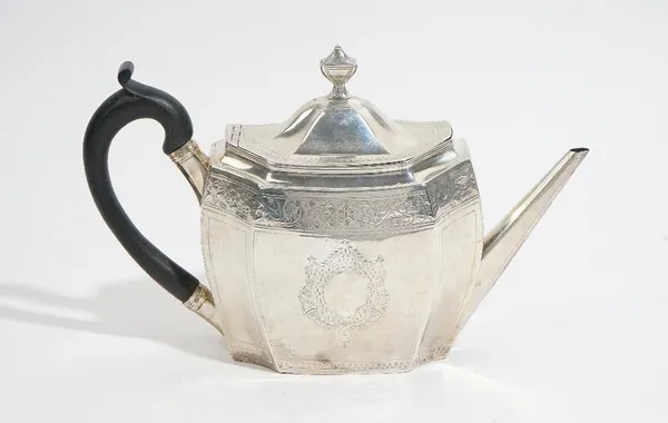 A George III silver teapot, of oval panelled form, with engraved decoration, tapered straight spout, the hinged lid with an urn finial, with a replace