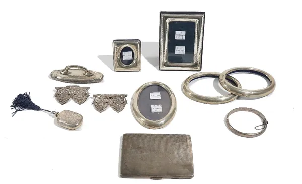 Silver and foreign wares, comprising; a rectangular cigarette case, with engine turned decoration, a two piece waistbelt buckle, an oval hinged bangle