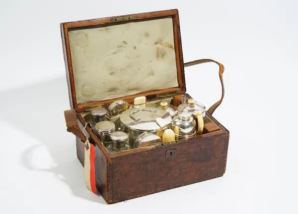 A Victorian leather cased travelling tea set, comprising; two silver spoons, London 1876 and a silver lid to one glass jar, London 1873, (probably rep