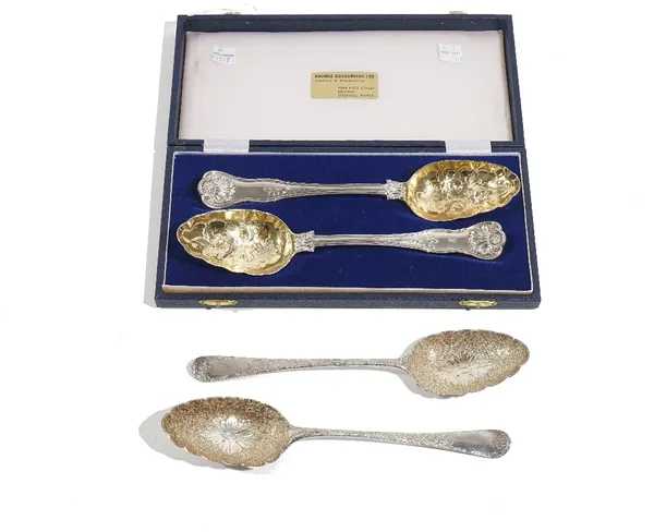 A pair of silver berry spoons, as converted from tablespoons, having gilt bowls, London 1823, with a later case and two similar dessert serving spoons