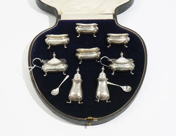 A silver eight piece condiment set, comprising; two mustard pots, with blue glass liners and two mustard spoons, four salts and two pepperettes, Birmi