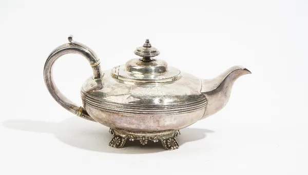 A George IV silver teapot, of compressed circular form, the body decorated with a reeded band, raised on shell capped feet, London 1829, gross weight